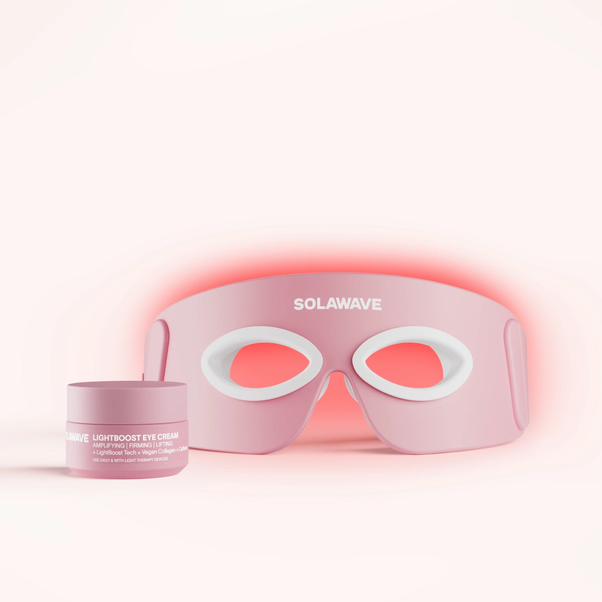 A person using a pink skincare device on their forehead with dotted lines.