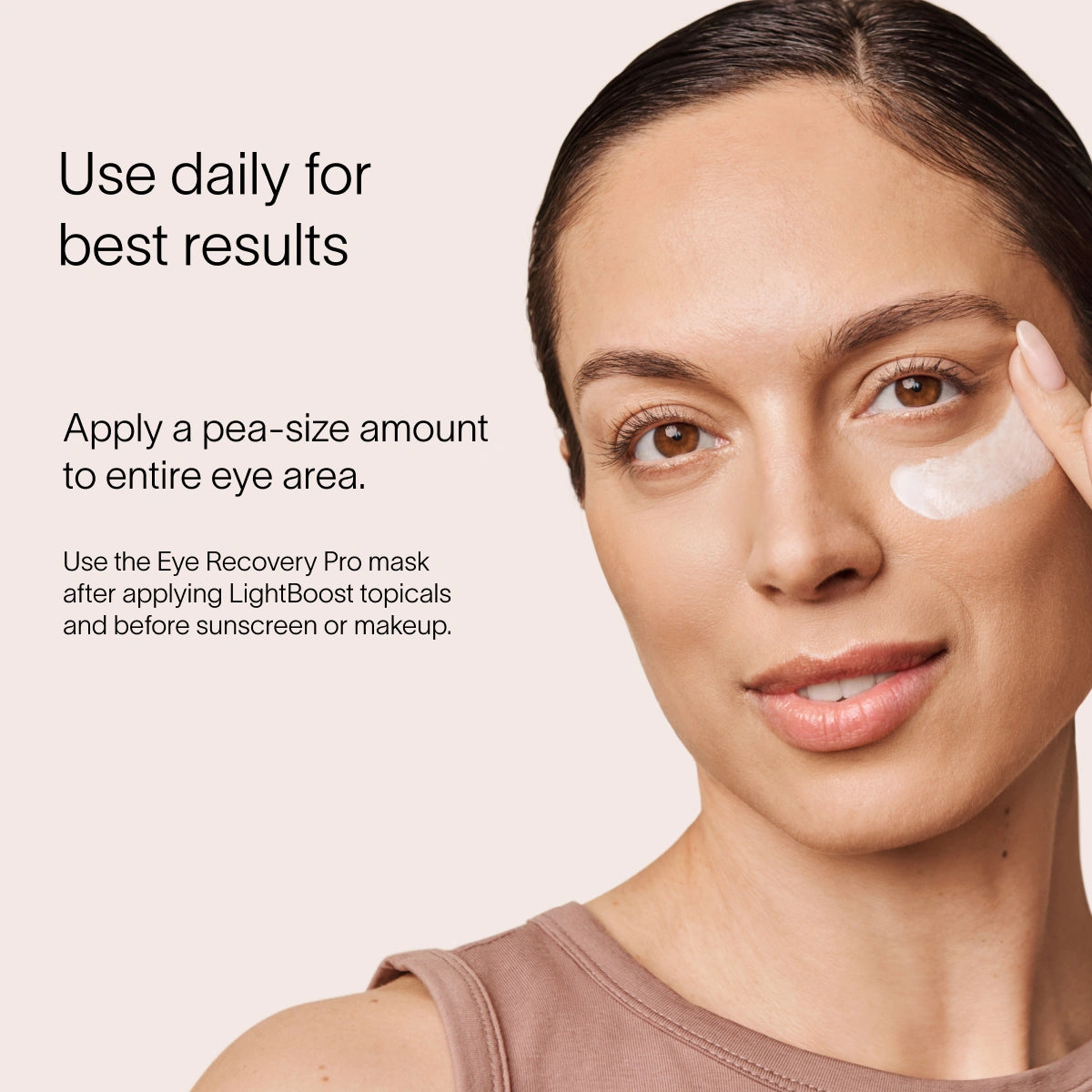 A person applies LightBoost Eye Cream under their eye, showcasing Solawave skincare enriched with vegan collagen. Text reads: Use daily for best results. Apply a pea-size amount to entire eye area. Use the Eye Recovery Pro mask after applying LightBoost and before sunscreen or makeup.