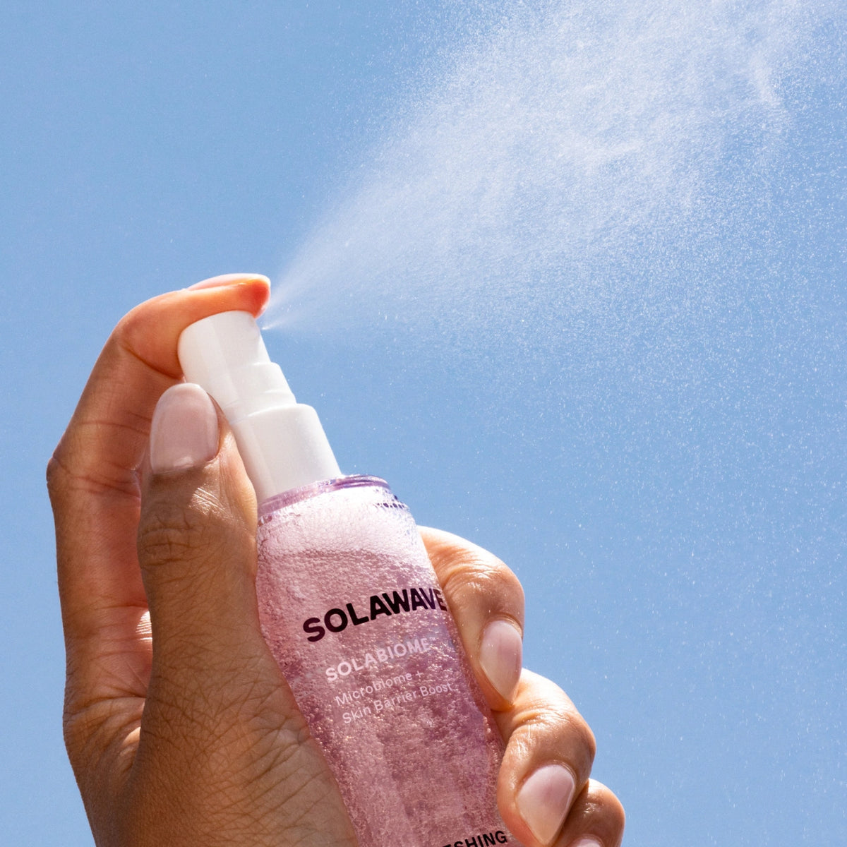 A product image of the Solawave Pre- & Probiotic Refreshing Jelly Face Mist being sprayed