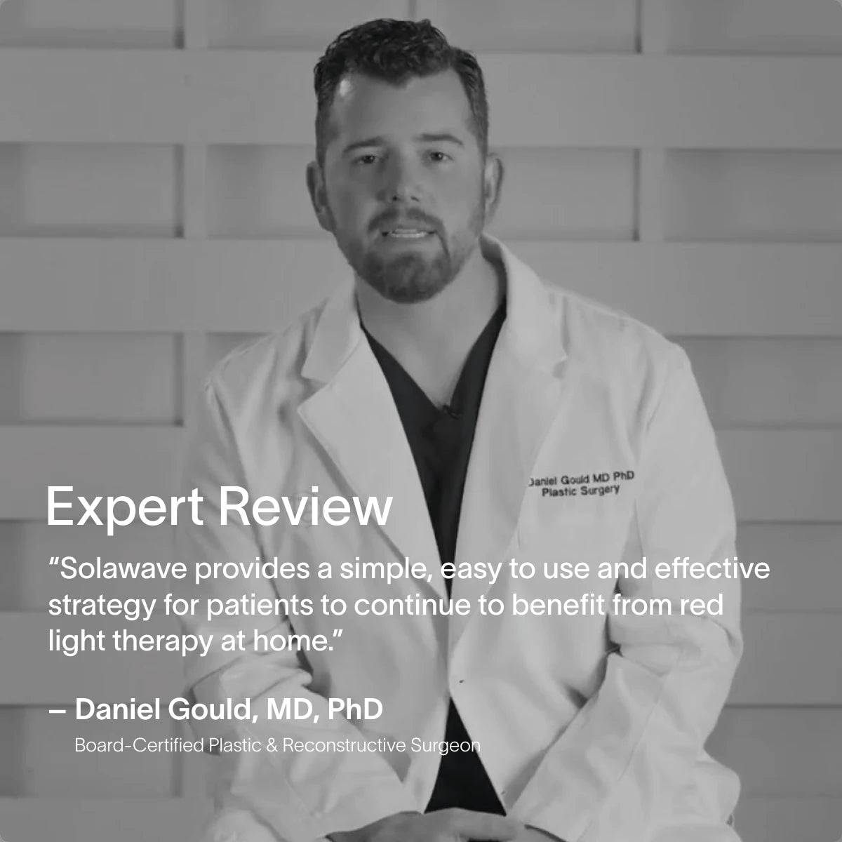 A man in a medical coat sits against a wooden paneled background. Text reads: Expert Review. Solawave offers an easy and effective way for patients to use red light therapy at home with the 4-in-1 Skincare Wand & 3-Month Serum Kit. - Daniel Gould, MD, PhD.