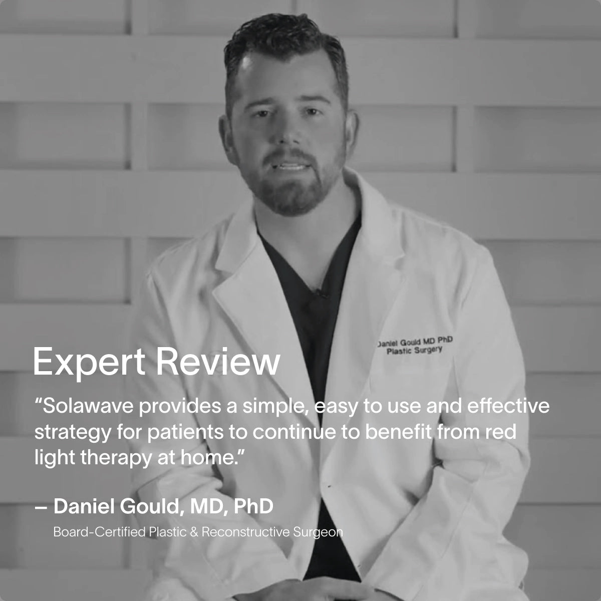 A man in a medical coat sits against a gray backdrop. Text on the image reads: Expert Review - The SolaWave 2-in-1 Face & Body Mini Starter Kit is an easy-to-use skincare tool offering effective red light therapy at home. Signed by Dr. Daniel Gould, Plastic Surgeon.