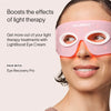 A woman wears a pink Solawave light therapy eye mask. The text states, Boosts the effects of light therapy, and suggests using it with LightBoost Eye Cream, enriched with growth factors, plus Eye Recovery Pro for better results.