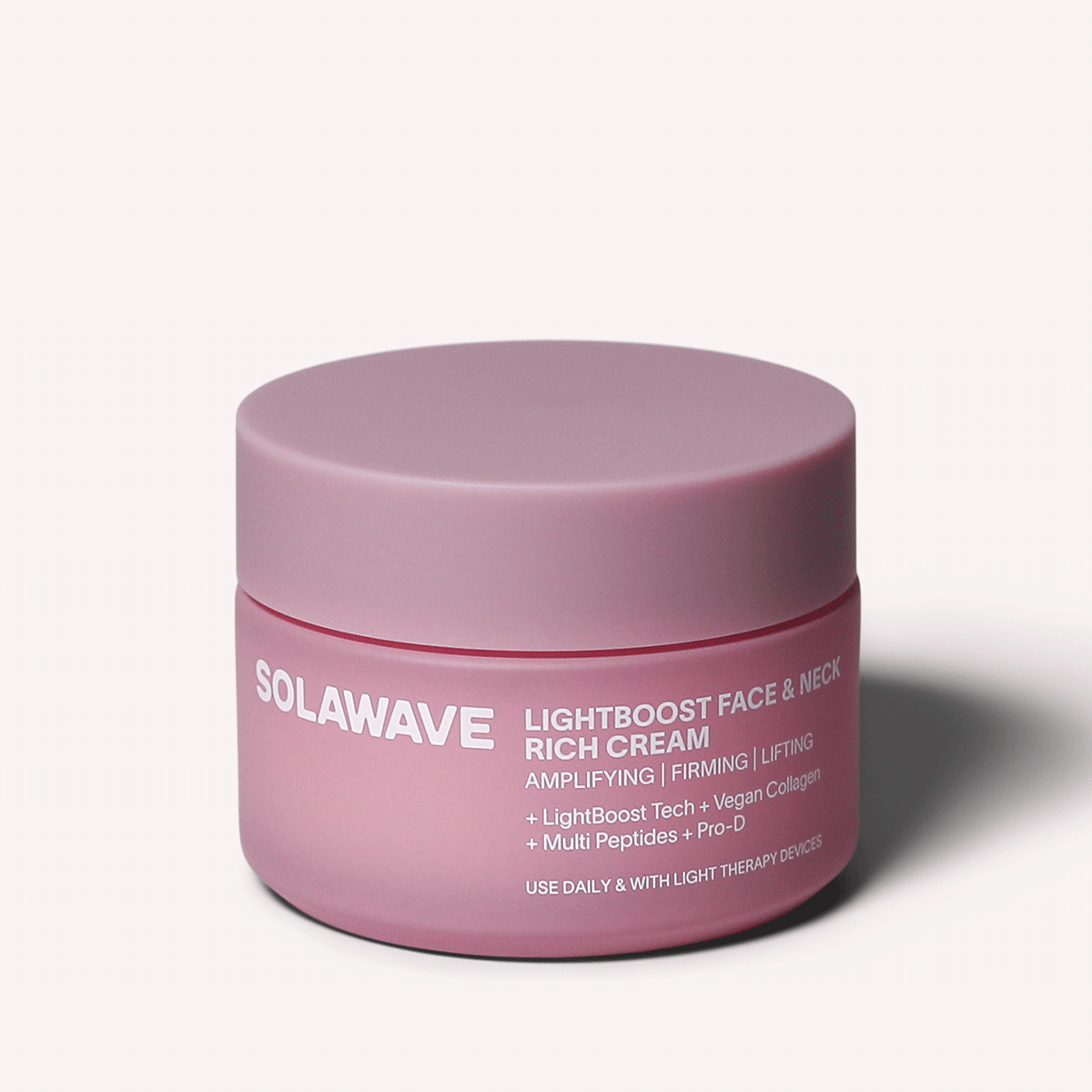 A pink jar of Solawaves LightBoost Face & Neck Rich Cream, a skin-strengthening product with firming and lifting benefits. Infused with vegan collagen and multi peptides, its LightBoost Tech complements light therapy devices for daily use.