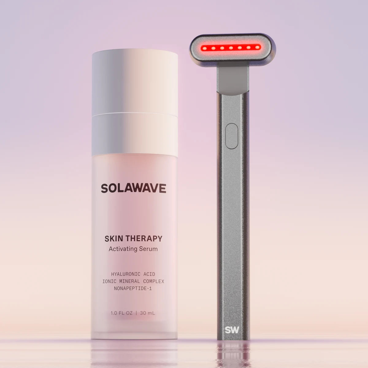 The Solawave 4-in-1 Red Light Therapy Skincare Wand & Activating Serum Kit, in a charcoal hue, features a Radiant Renewal Wand with red LED lights and serum rich in hyaluronic acid for revitalized skin against a gradient backdrop.