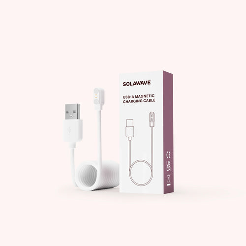 Coiled white USB-A magnetic charging cable with a visible USB connector is placed next to its box labeled Solawave Magnetic Charging Cord Replacement for Radiant Renewal Skincare Wand and features compliance icons (CE, UKCA).